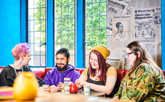 Friends sitting around a table laughing